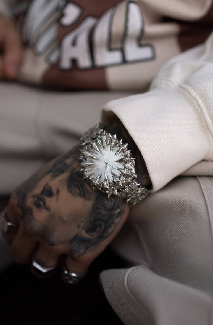 Crystal Spire spiked watch worn on wrist, highlighting its aggressive chrome design and fashion-forward appeal in streetwear styling.