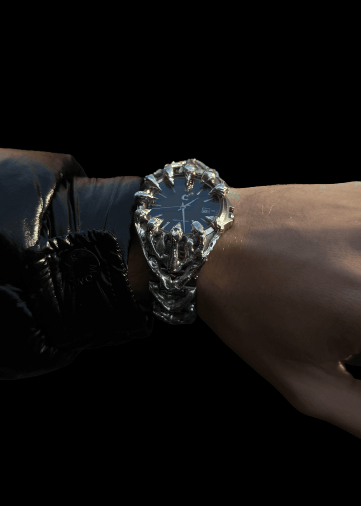 Side angle of ABYSS Chrome Watch on wrist, emphasizing the claw-like chrome structure and sleek black sunburst dial.