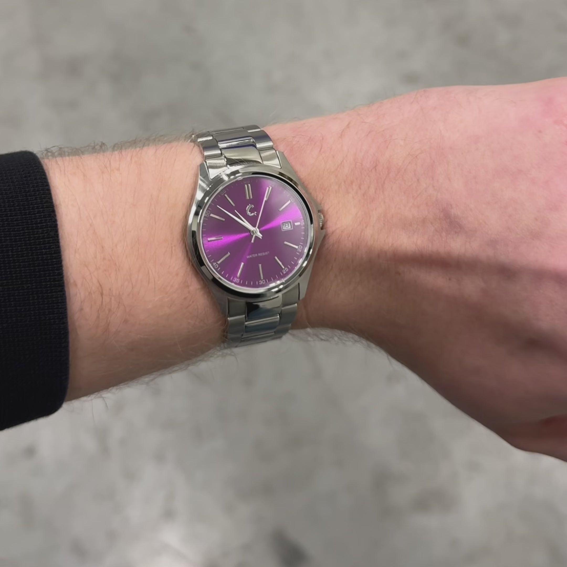 AMETHYST watch on wrist showcasing its sleek stainless steel band and striking purple dial, perfect for modern fashion.