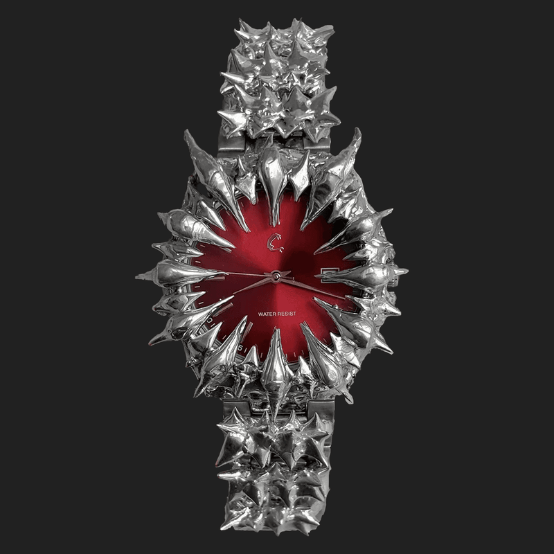 Ruby Thorn - Chrome Watch with red sunburst dial and spiked bezel design, quartz movement and 50m water resistance, shown on black background.